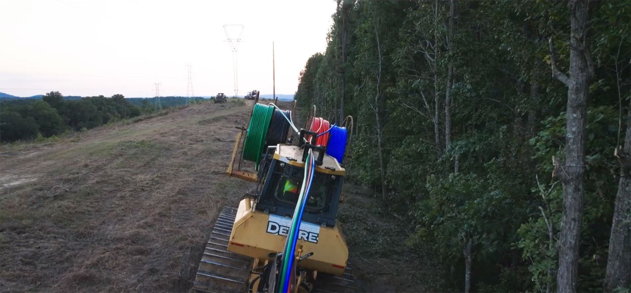 Machine laying fiber-optic cable
